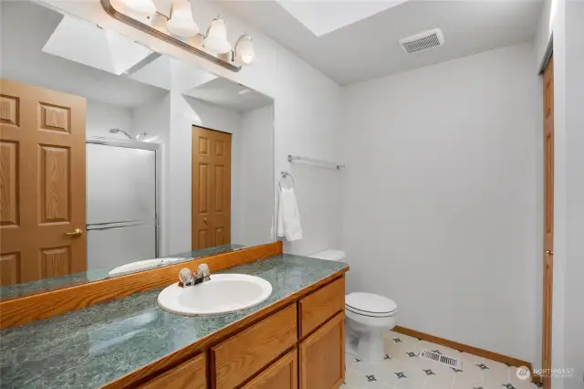 Plenty of room to begin and end your day in the attached 3/4 bathroom. Great counter space and the linen closet provides nice storage options.