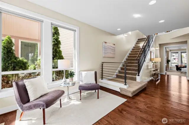 Open metal railing on the Staircase leads you up to the Main Living Area. The Family Room, Bedroom #3 and a Full Bathroom are on the main level.