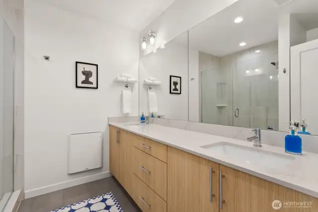 Large primary bathroom with two sinks and plenty of storage.