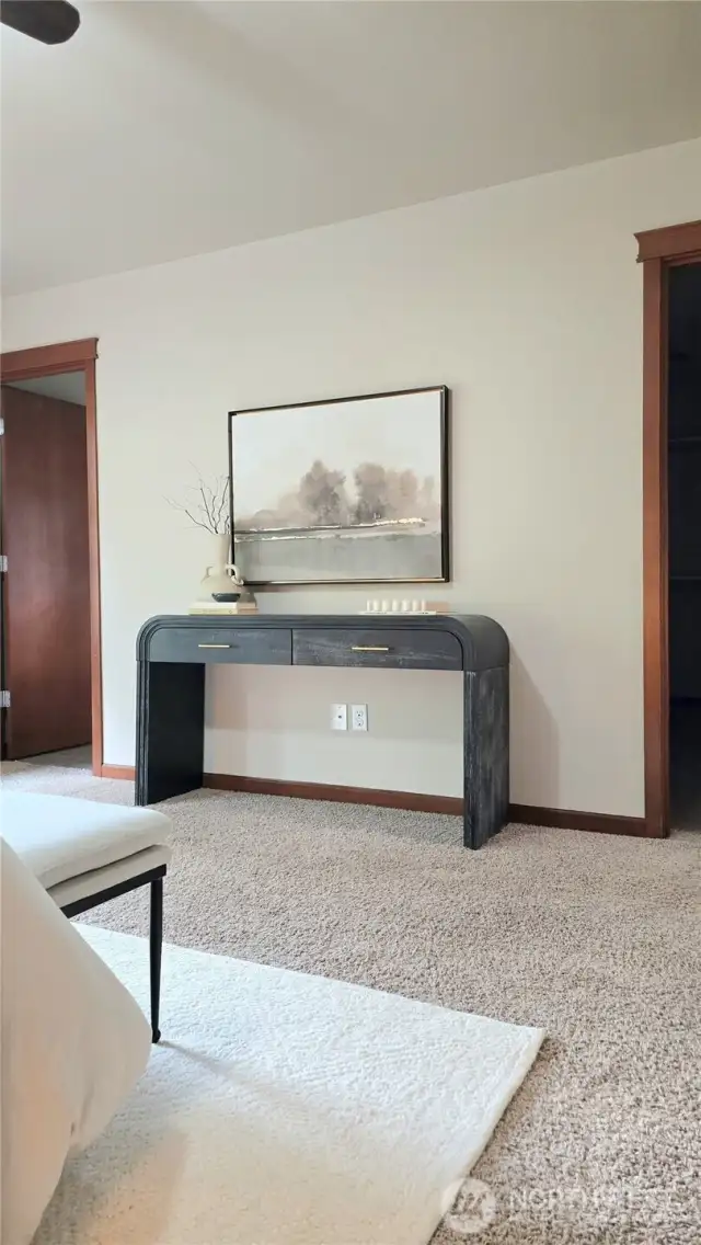 The door to the left leads to the primary bathroom and the door to the right leads to the walk-in-closet.