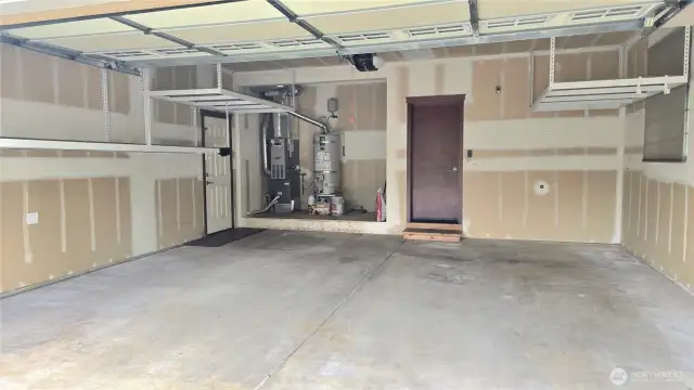 The garage offers convenient ceiling racks for more storage, as well as a side door to the yard.