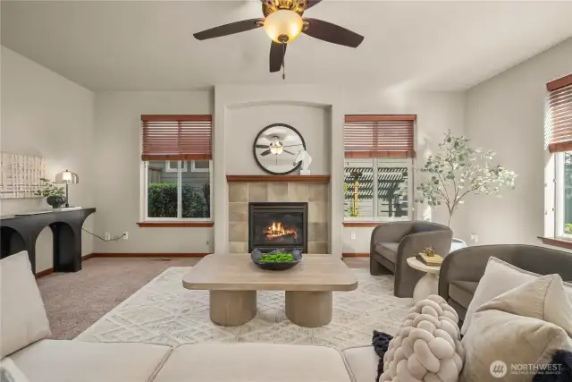 The large living room features lots of windows, flooding the space with natural light.