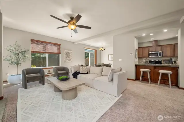 Open floorplan with defined spaces for kitchen, dining and living.