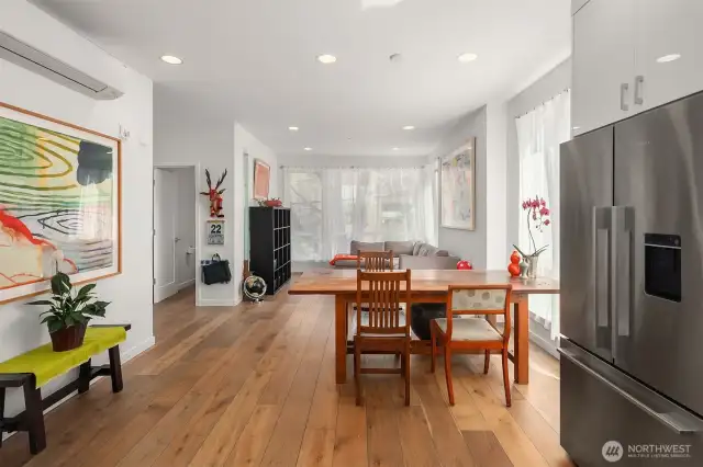 From the kitchen you can see how the interior main spaces communicate in dialog together.  Above the painting on the wall to the left is a mini-split heat and air conditioning unit.  Each floor has its own zoned air controls.