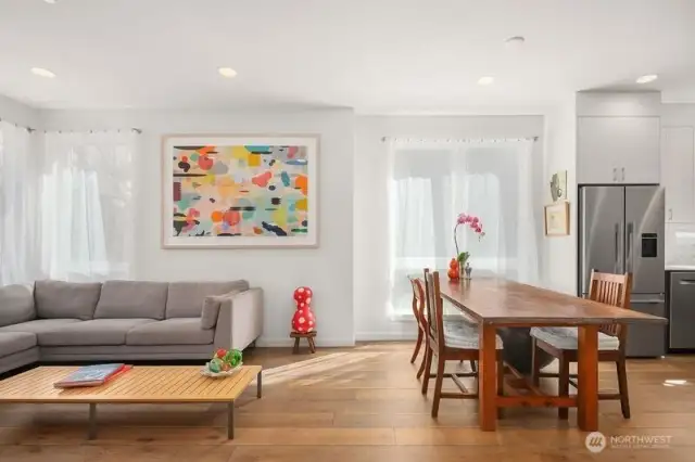 Entering the Second floor, one sees a partial view of the living room and dining area near the kitchen. Natural light throughout, and recessed lighting on all floors. Ceiling height on this floor is close to nine feet.