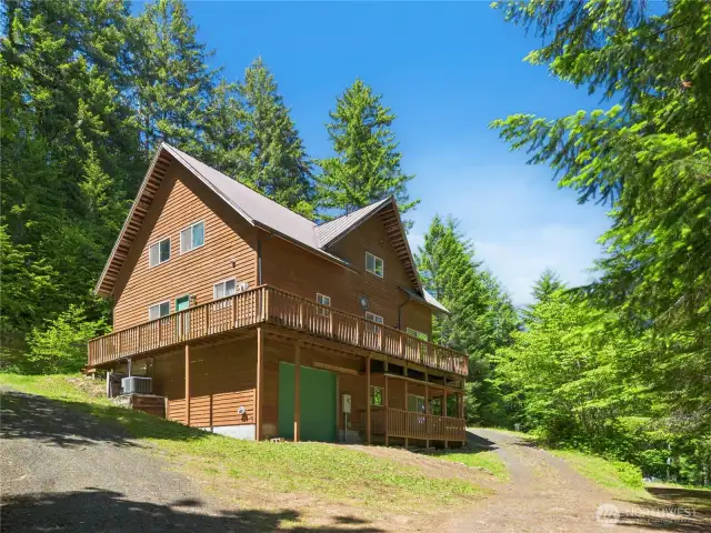 The driveway opens up to a lovely home situated perfectly among the trees.