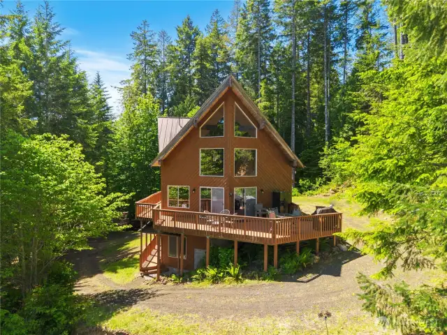 Step from the deck into a serene outdoor setting—perfect for relaxing or entertaining amidst nature.