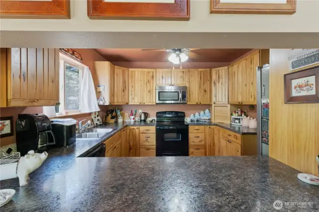 A raised bar separates the kitchen and dining area, enhancing functionality in both spaces.