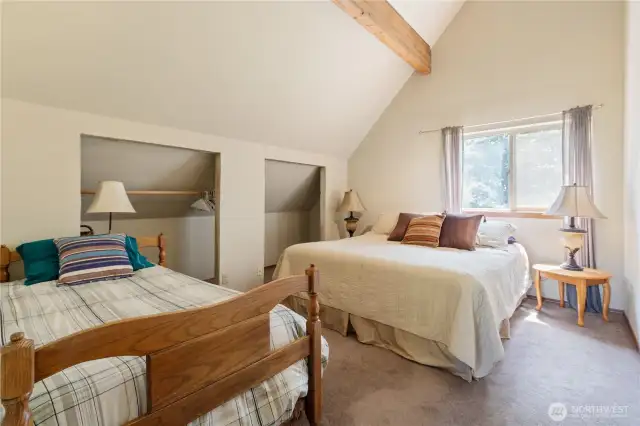 Upstairs includes two additional bedrooms, each with vaulted ceilings and generous closet space.