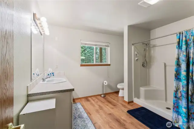 Spacious 3/4 bathroom on the downstairs level provides practicality and room to move.