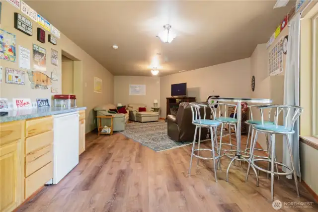 Spacious bonus area is equipped with a sink, dishwasher, and ample counter space—ideal for hosting, hobbies, or extended living needs.