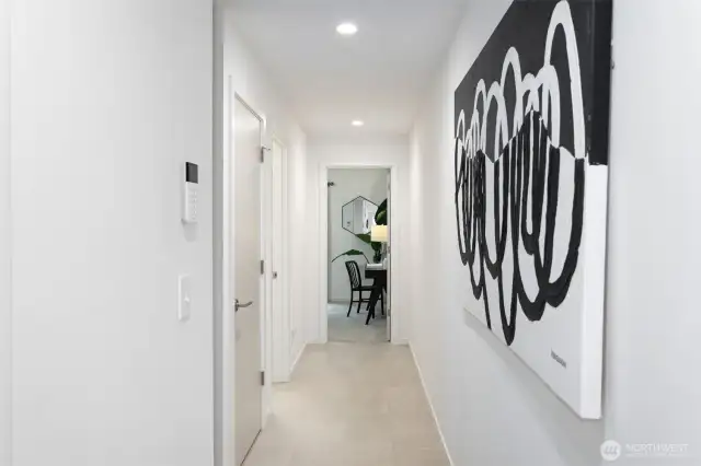 Head down the ground-level hall to the full bathroom & one of the two bedrooms.