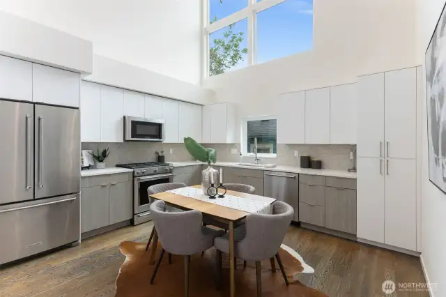 This gorgeous chef's kitchen is equipped with tons of cabinets for storage, quartz countertops, stainless appliances & TONS of natural light!