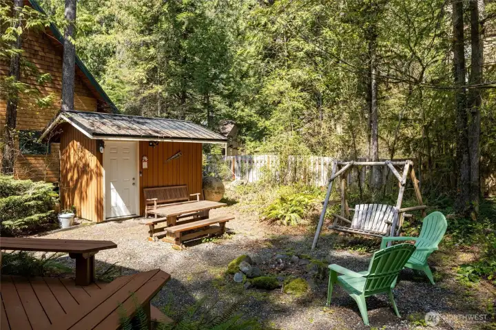 Storage shed plus fire pit area in the backyard.