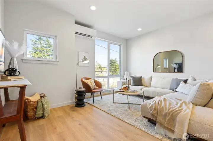 Let the natural light pour in. This airy living room has warm tones, soft textures, and modern edges.