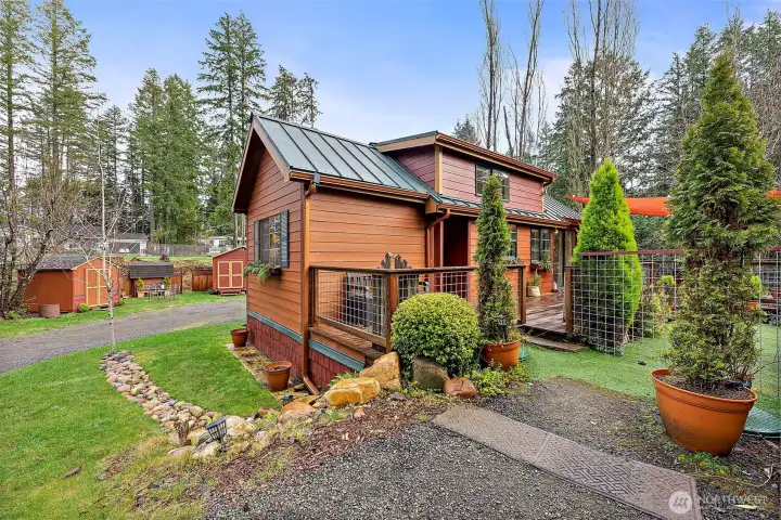 Custom tiny home in the Wye Lake Community in South Kitsap, set on nearly ¾ acre peaceful setting featuring several outbuildings and a greenhouse for added flexibility and lifestyle living.