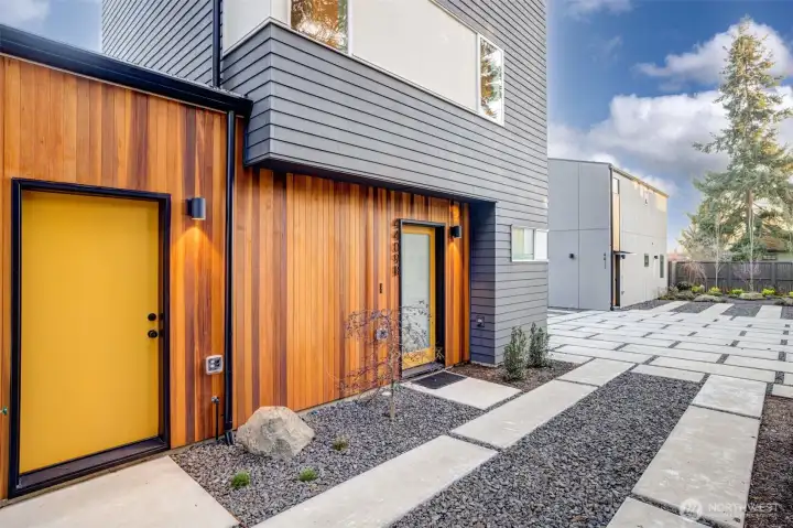 Vertical cedar siding defines the exterior with warmth and texture, setting the architectural tone.