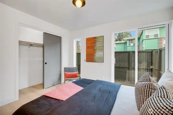 Ample storage space in the deep, lit closet. Vertical windows and the large slider door allow natural light to flow in. Off the slider area is a small patio perfect for a small bistro table.