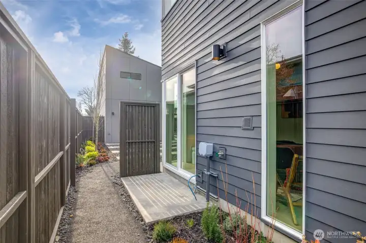 Entry-level guest suite features a large glass slider to a private patio, offering flexible work-from-home potential.