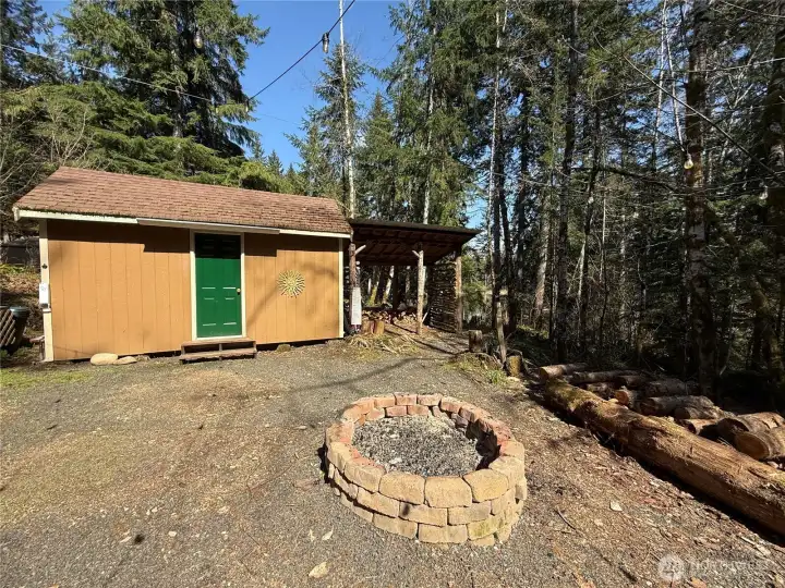 Large outbuilding/shop w/ tons of storage.