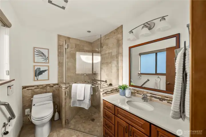 The primary bath features an updated shower & luxury bidet-style toilet.