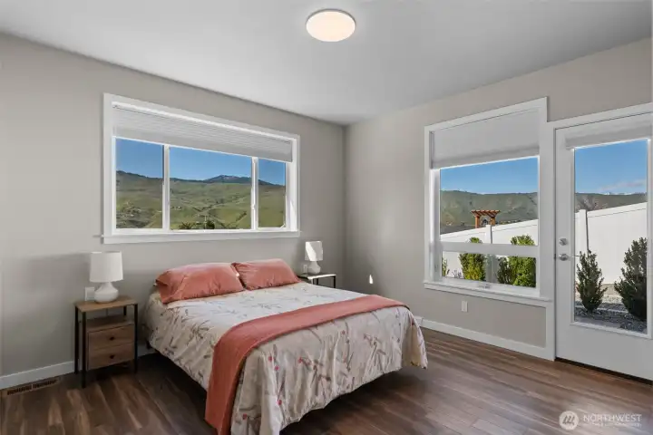 Primary bedroom with patio facing West Enchantment Mountain views