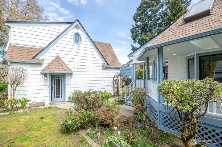 The beautiful carriage house and garage is just steps from the home.