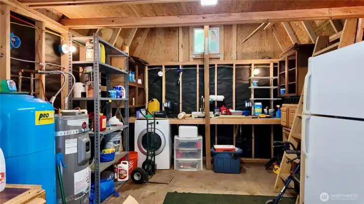 Includes loft, workbench, dryer, and existing plumbing/power for future washer.