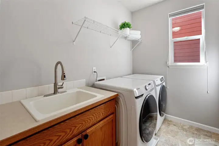 Utility room with sink and wi-fi energy efficient  washer and dryer (purchased in July 2021).