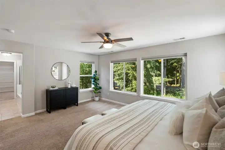 Primary Bedroom (1 of 4) with abundant natural light and ceiling fan.