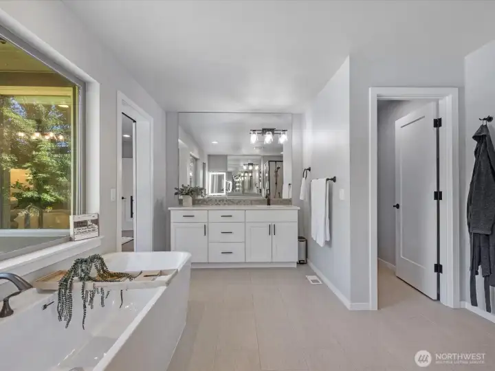 Spa-inspired primary bathroom with thoughtful details and generous space Spa-inspired primary bathroom with thoughtful details and generous space