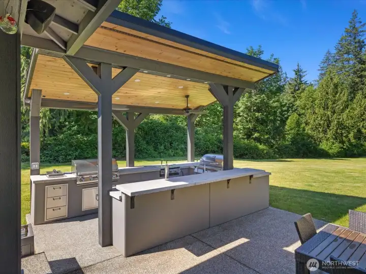 Incredible outdoor kitchen designed for year-round entertaining. Features ReqTec smoker, sun fire grill, two tap kegerator, and more! Incredible outdoor kitchen designed for year-round entertaining. Features ReqTec smoker, sun fire grill, two tap kegerator, and more!