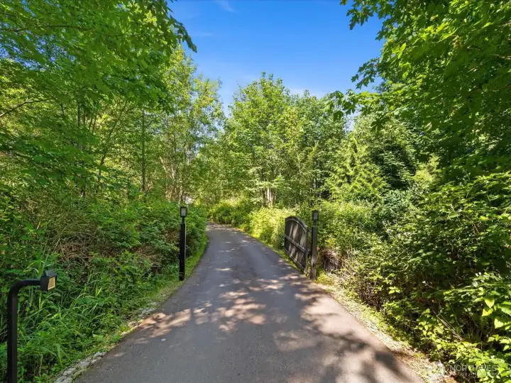 A long driveway and beautiful setting create a grand first impression A long driveway and beautiful setting create a grand first impression