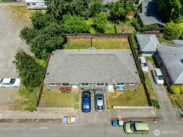 Bird's-eye view of the duplex featuring individual yard spaces and convenient parking.
