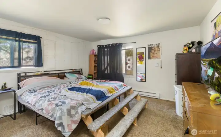 Bedroom offers ample floor space & natural light.