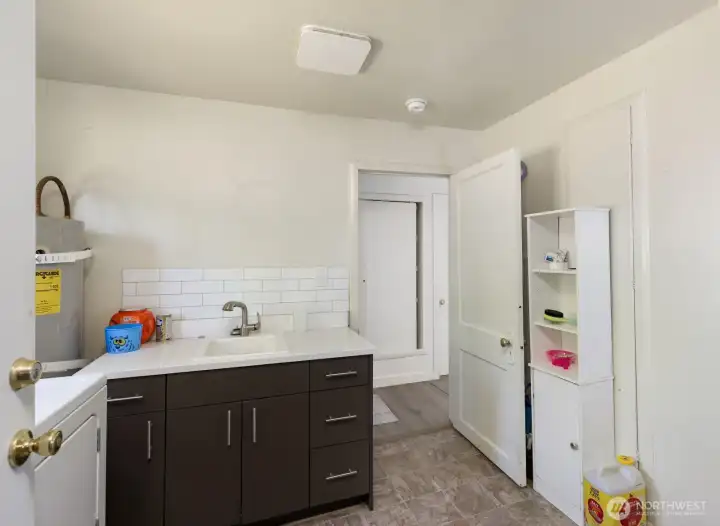 Dedicated laundry room features a utility sink.