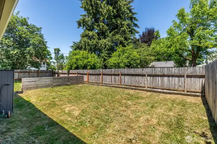 Fenced yard provides a versatile outdoor area with room for a variety of uses.