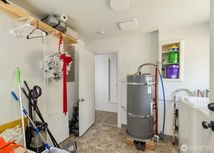 Utility room provides space for laundry, storage, and everyday organization.