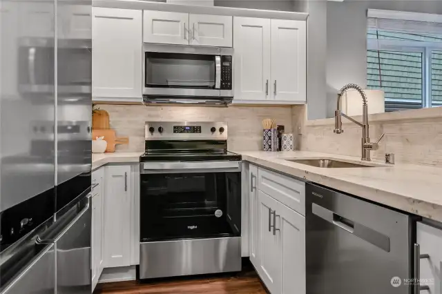 Enjoy cooking in a newly renovated kitchen with all new Stainless-Steel appliances: Whirlpool counter depth refrigerator, dishwasher, microwave and stove/oven.