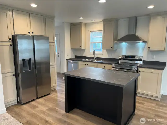 Kitchen with pantry and stainless steel appliances.