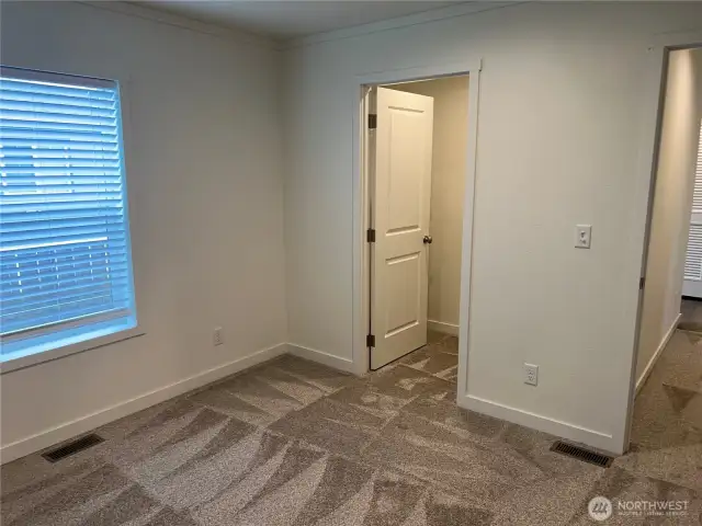 Primary bedroom looking at walk in closet.