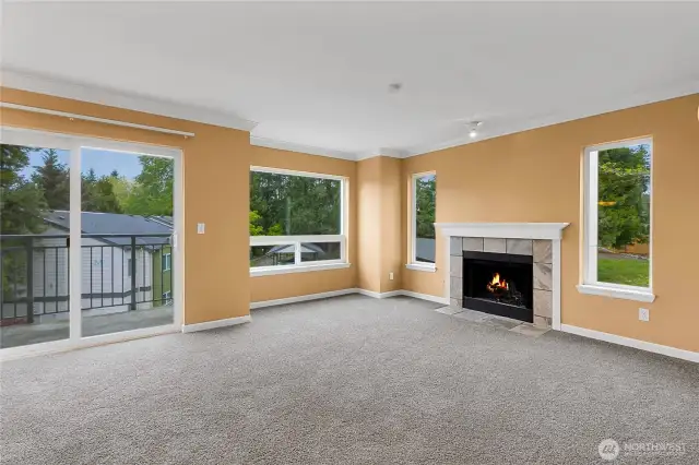 Living room with terrific natural light, fireplace and balcony