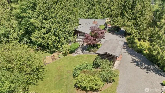 Multiple outbuildings, including greenhouse, offer space for hobbies, tools, and weekend projects.