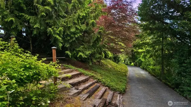 Meandering paths lined with wisteria, honeysuckle, and raspberry canes create a true storybook setting.
