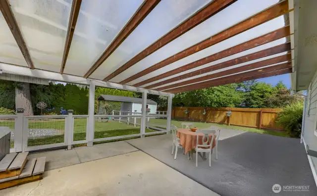 back patio, perfect for entertaining and BBQ cooking, hanging out in theGorgeous covered  big jacuzzi and watching the game on the exterior mounted tv. Also custom fencing for kis playing or pets