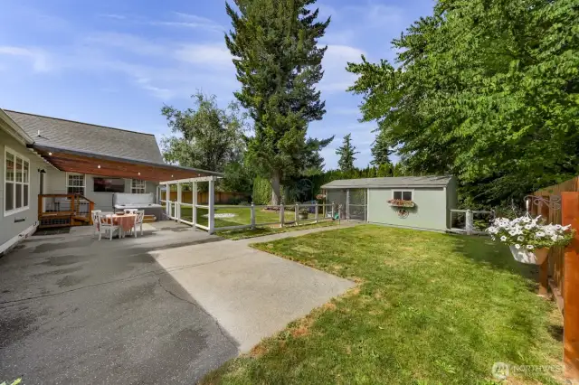 back patio, perfect for entertaining and BBQ cooking, hanging out in theGorgeous covered  big jacuzzi and watching the game on the exterior mounted tv. Also custom fencing for kis playing or pets