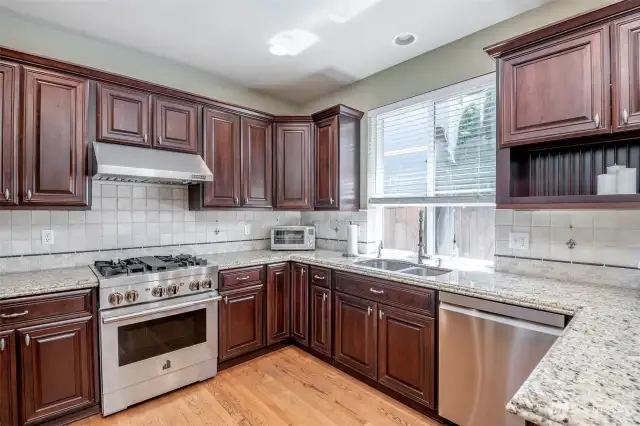 Amazing Kitchen!  Custom Cabinets & Granite Counters + Commercial Jenn Air Gas Oven & Cook Top w/ Commercial Vent Hood.  Refrigerator also Jenn Air.  All APPLIACNES Convey!