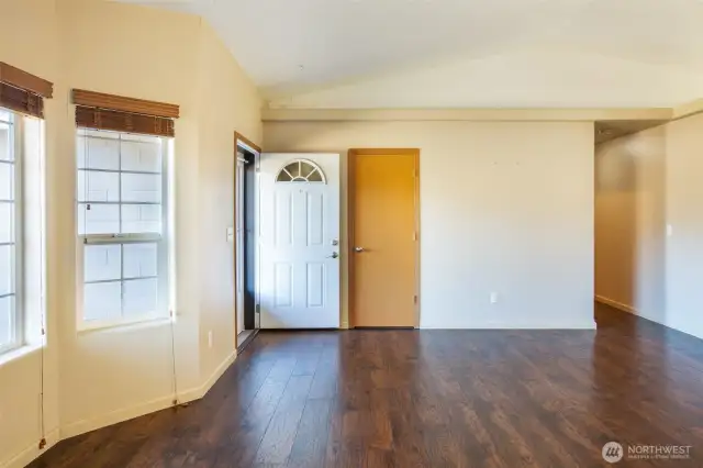 The bay window on the front of the house lets in lots of light. All the windows (except the sliding glass door) have wide, wooden blinds.