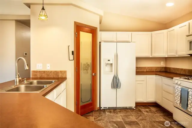 More kitchen views. Note the microwave over the range and the stack of drawers next to the range.