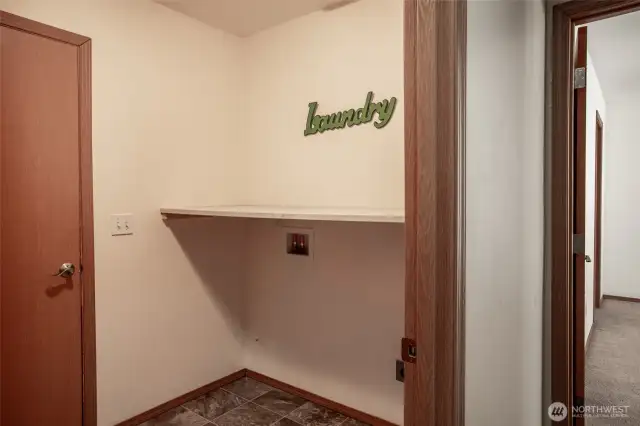 A very necessary room. Washer and dryer fit into this space with cleaver shelf above. Door leads to the generous 2 car garage.